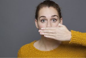 woman covering mouth bad breath